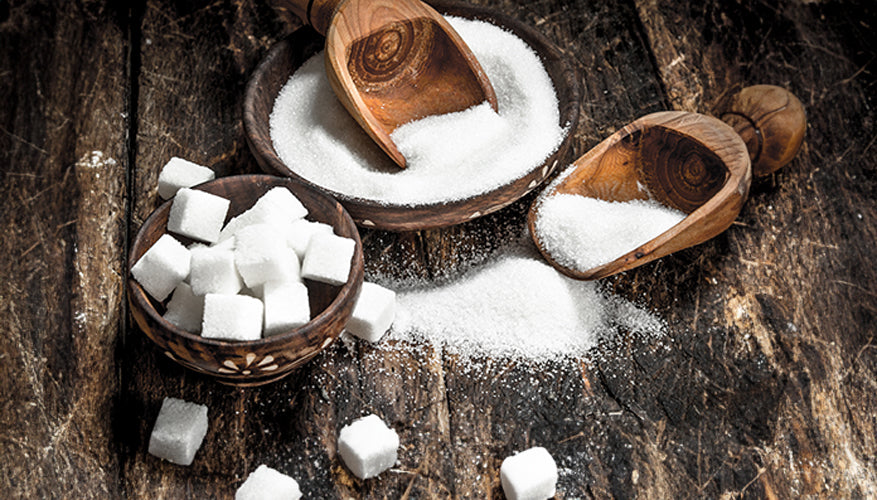 refined sugar pile with scoops and sugar cubes